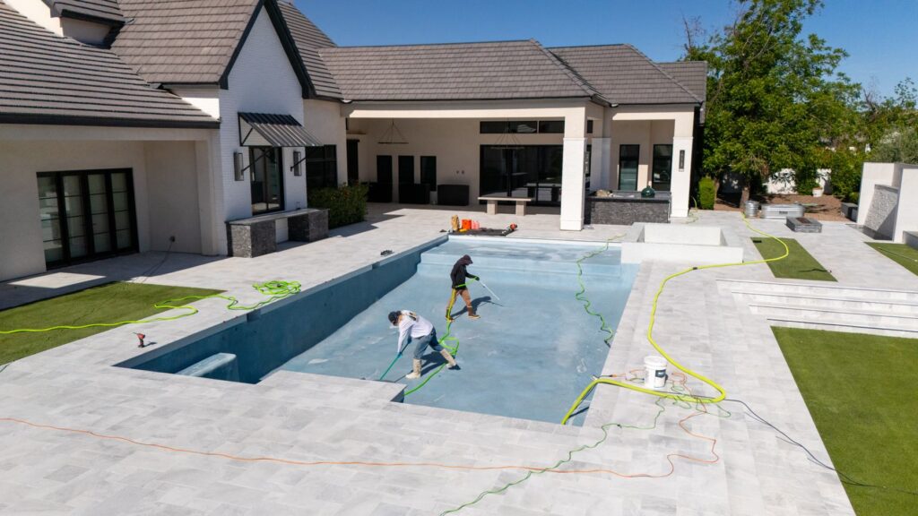 Stay Fresh Pools crew cleaning a large backyard pool in the East Valley, Arizona